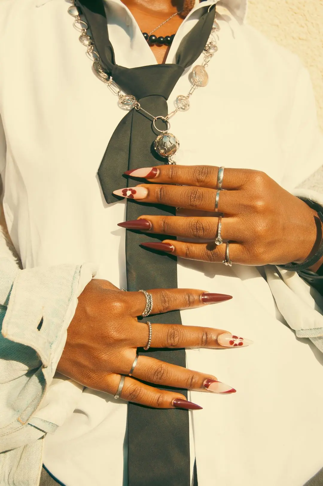 Hands with long decorated nails and rings